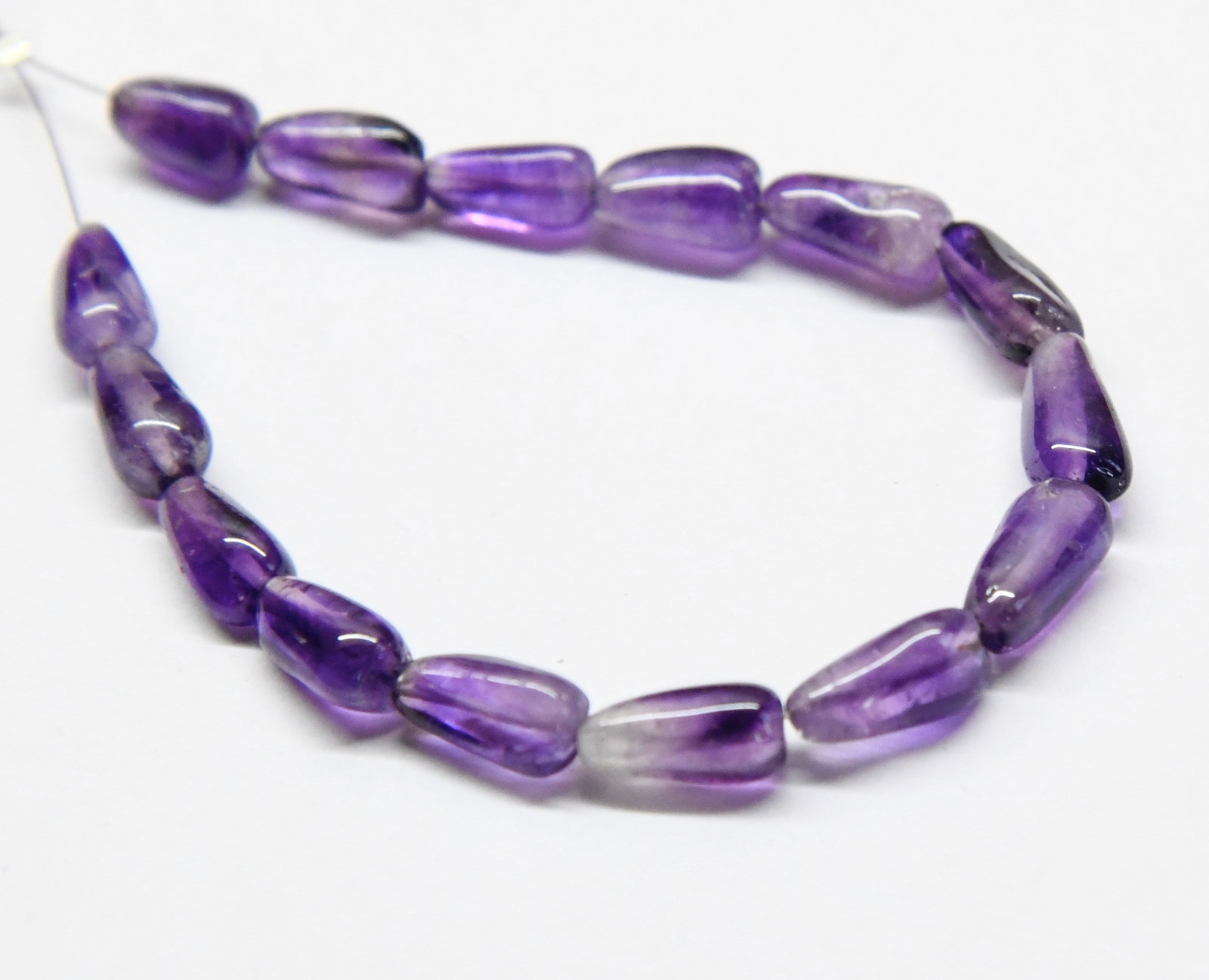 NATURAL AMETHYST BEADS DROPS 5X9 - 5X10 MM, 15 PCS: These are natural, earth mined and hand crafted with precision. Stone: Amethyst, Stone Shape: Drops, Stone Size: 5x9 - 5x10 mm, Weight: approx. 27 carats. The photographs are generally enlarged to sho