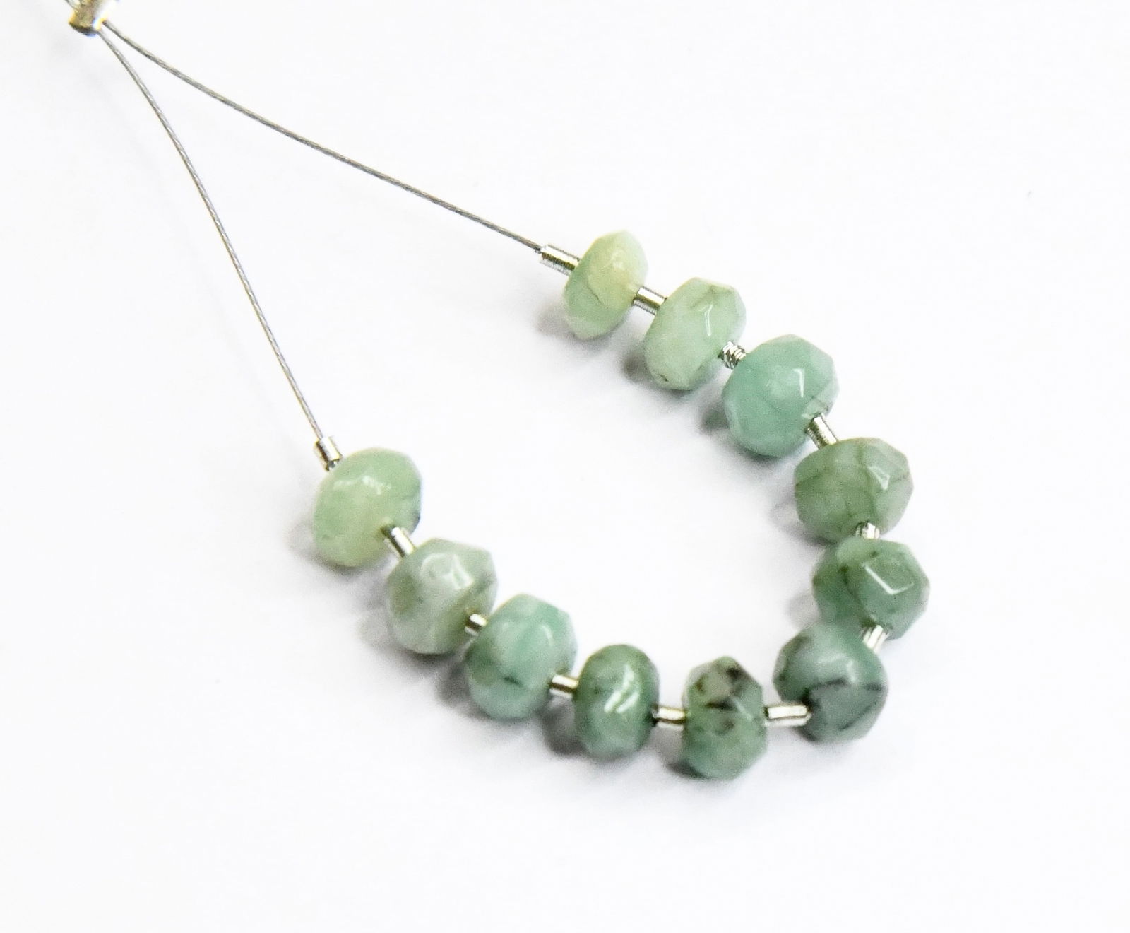 NATURAL EMERALD BEADS FACETED RONDELLE 5 MM 11 PCS (4 TASSELS): These are natural, earth mined and hand crafted with precision. Stone: Emerald, Stone Shape: Faceted Rondelle, Stone Size: 5 mm, Width: 2.5 - 3.5 mm, Weight: approx. 7.75 carats. The photographs are e