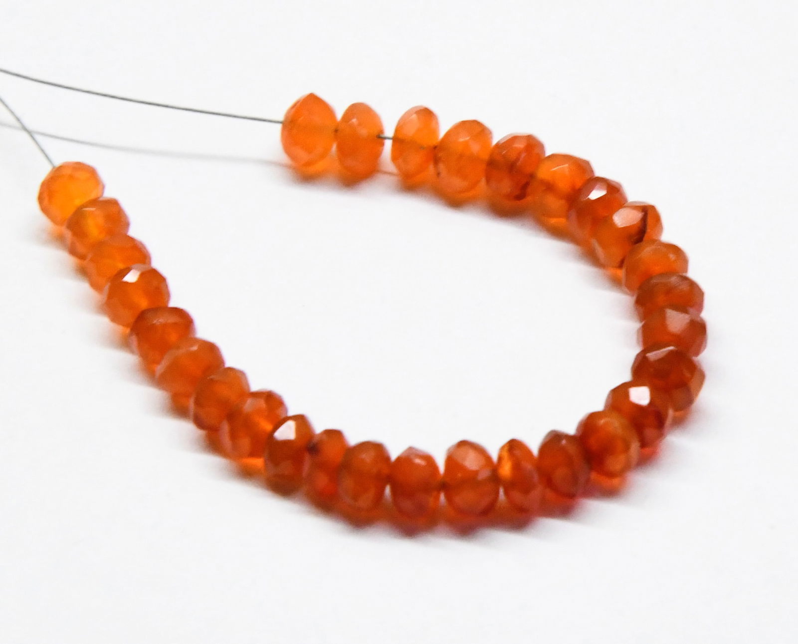 NATURAL CARNELIAN BEADS RONDELLE 5 - 5.5 MM, 29 PCS (3 TASSELS): These are natural, earth mined and hand crafted with precision. Stone: Carnelian, Stone Shape: Faceted Rondelle, Stone Size: 5 - 5.5 mm, Width: 2.5 - 3.5 mm, Weight: approx. 21 carats. The photographs
