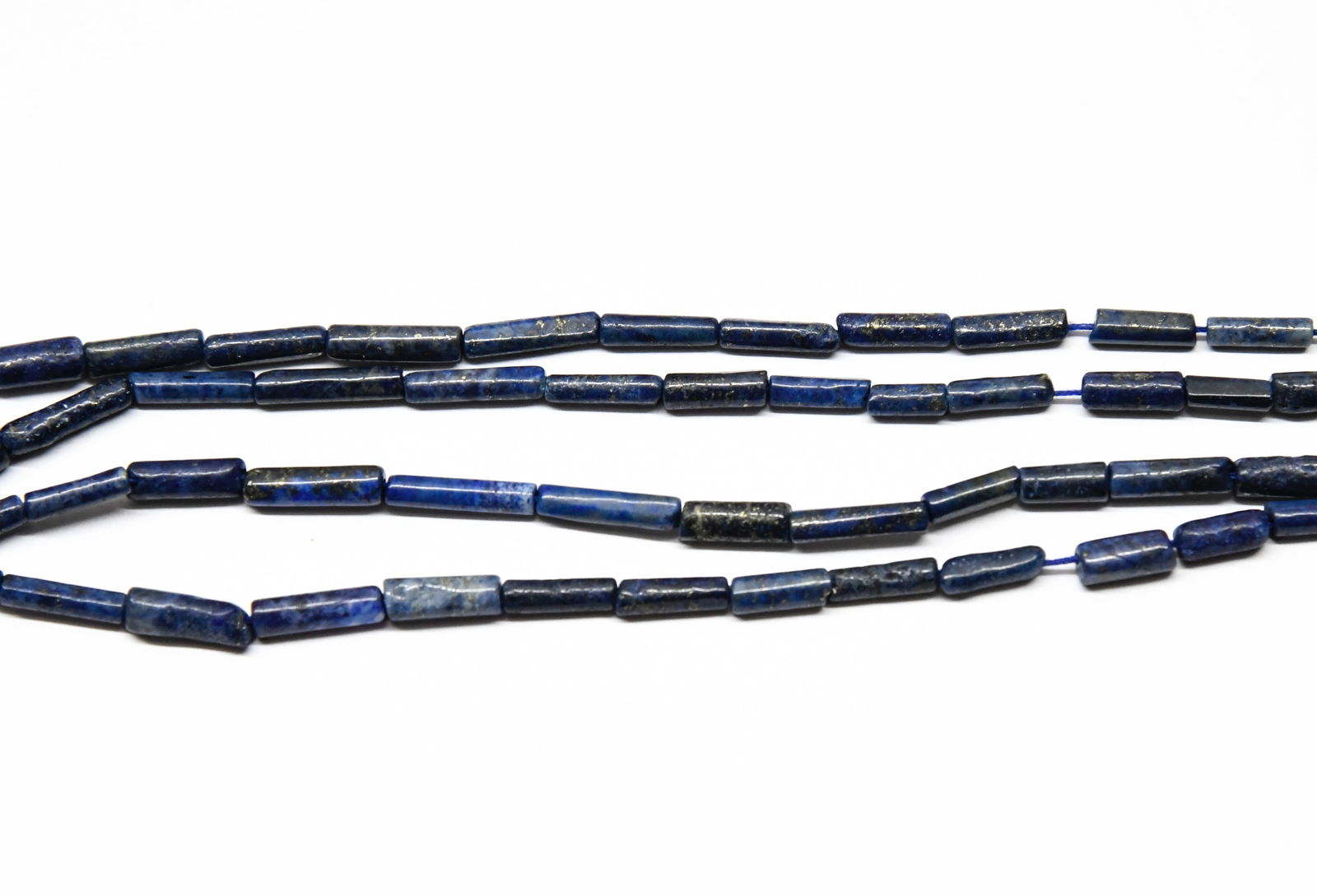 NATURAL LAPIS LAZULI BEADS TUBE 3X6 - 3X12 MM, 12" STRAND (2 LINES): These are natural, earth mined and hand crafted with precision. Stone: Lapis Lazuli, Stone Shape: Tube, Stone Size: 3x6 - 3.5x12 mm, Weight: approx. 39 carats. The photographs are generally enlarged t