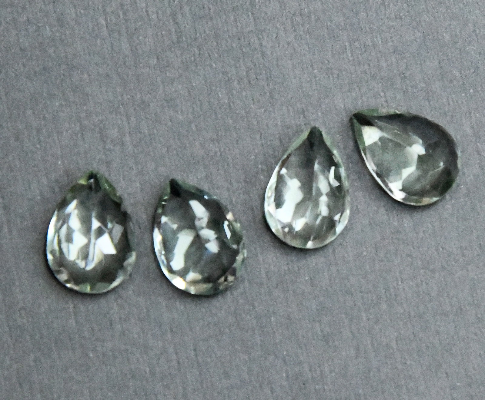 NATURAL GREEN AMETHYST BEADS FACETED PEAR 9.5X 13.5 MM - (4 PIECES): These are natural, earth mined and hand crafted with precision. Stone: Green Amethyst, Stone Shape: Faceted Pear, Stone Size: 9.5x13.5 mm, Width: 5 - 6.5 mm, Weight: approx. 17 carats. The photographs