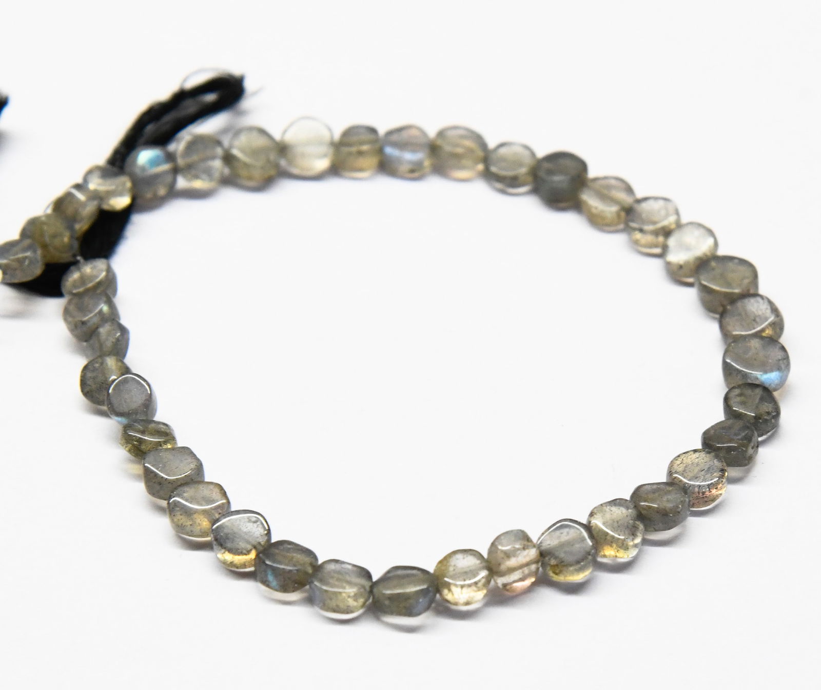 NATURAL LABRADORITE BEADS COIN 5 - 6.5 MM, 8" STRAND: These are natural, earth mined and hand crafted with precision. Stone: Labradorite, Stone Shape: Coin, Stone Size: 5 - 6.5 mm, Width: 2 - 3 mm, Weight: approx. 34 carats. The photographs are generally
