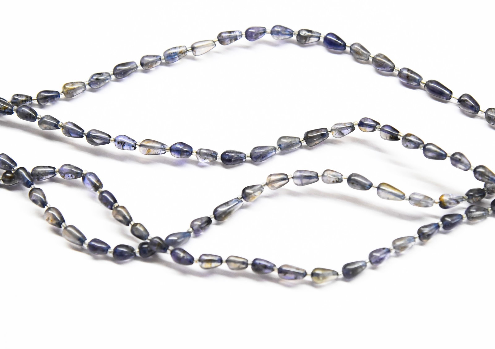 NATURAL IOLITE BEADS TOPDRILL DROPS 3X5 - 4X6 MM 7.5" STRAND, (2 LINES): These are natural, earth mined and hand crafted with precision. Stone: Iolite, Stone Shape: Topdrill Drops, Stone Size: 3.5x5 - 4x6.5 mm, Weight: approx. 17 carats. The photographs are enlarged to sho