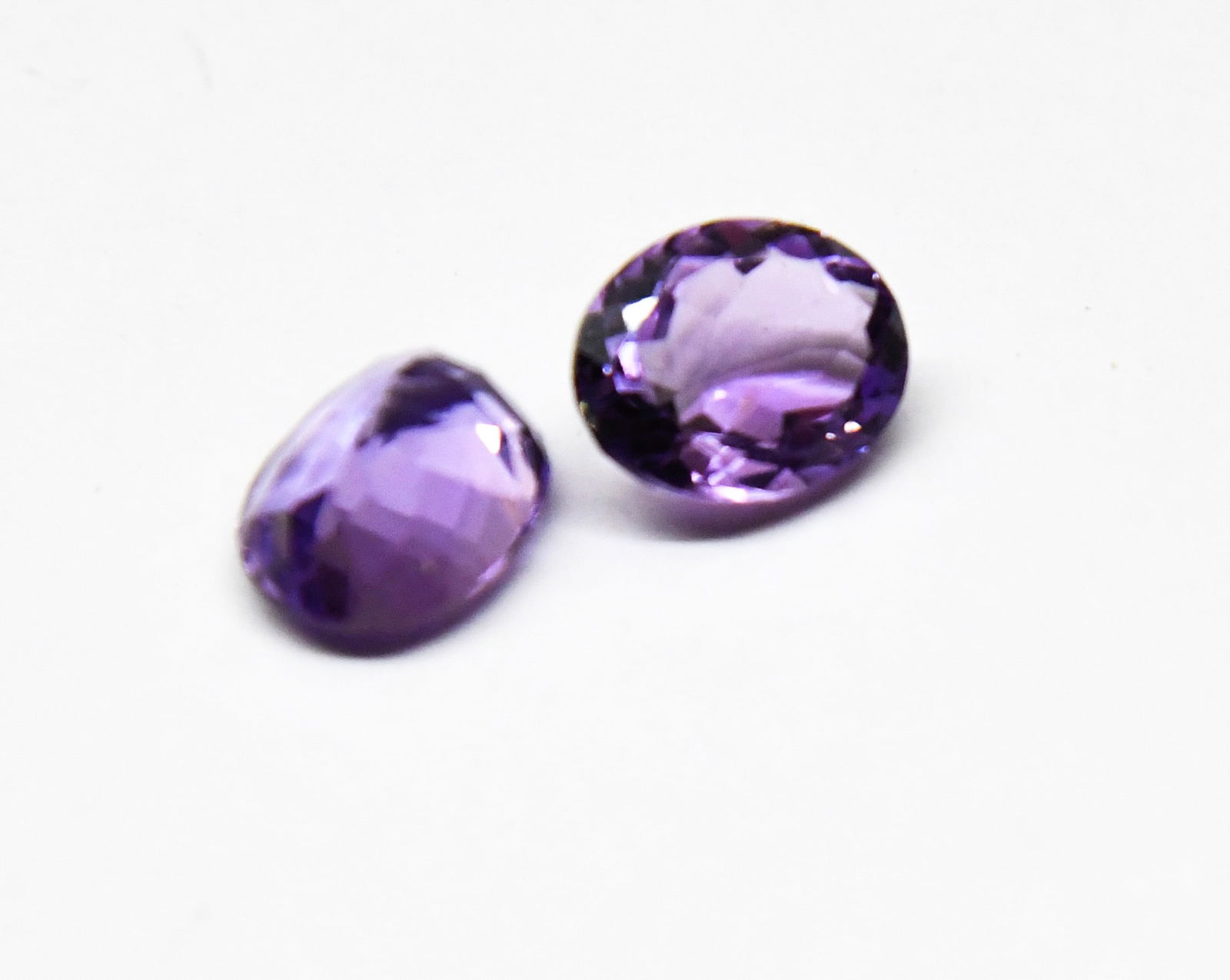 NATURAL AMETHYST FACETED CUTSTONE OVAL 9X11 MM 2 PCS: These are natural, earth mined and hand crafted with precision. Stone: Amethyst, Shape: Faceted Oval, Size: 9x11 mm, Width: 5 - 6 mm, Weight: approx. 6 carats. The photographs are enlarged to show the