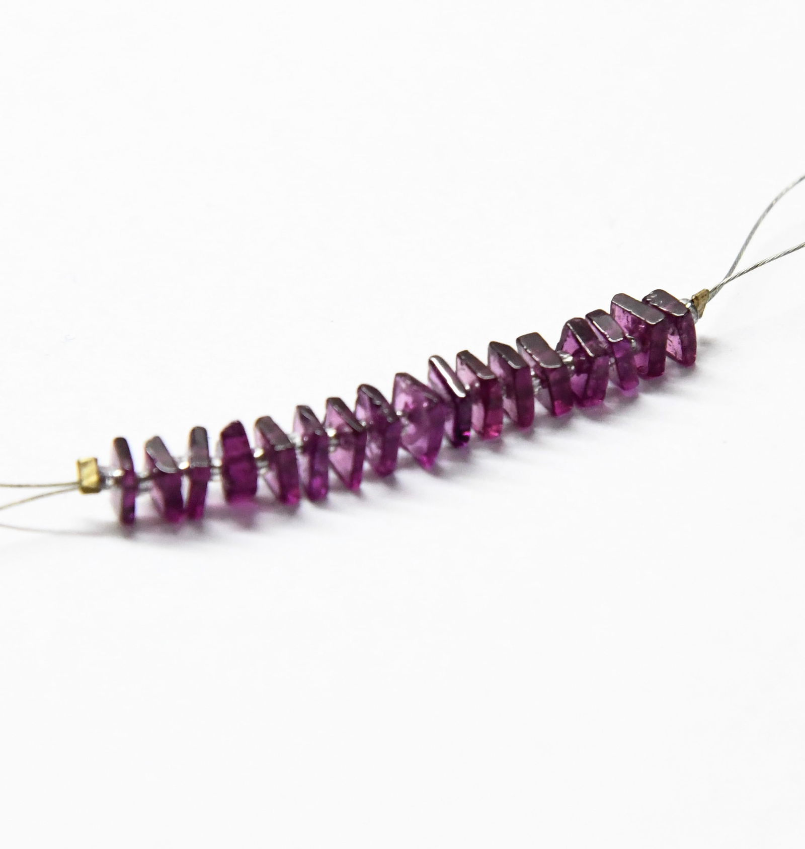 NATURAL RHODOLITE GARNET BEADS FLAT SQUARE 3.5 - 4.5 MM 17 PCS: These are natural, earth mined and hand crafted with precision. Stone: Rhodolite Garnet, Shape: Flat Square, Size: 3.5 - 4.5 mm, Width: 1 - 2 mm, Weight: approx. 8 carats. The photographs are enlarged