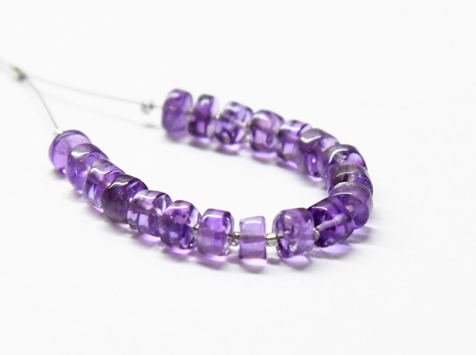 NATURAL AMETHYST BEADS TYRE 5.5 MM 19 PCS: These are natural, earth mined and hand crafted with precision. Stone: Amethyst, Shape: Tyre, Size: 5.5 mm, Width: 2.5 - 4 mm, Weight: approx. 9 carats. The photographs are enlarged to show the clarit