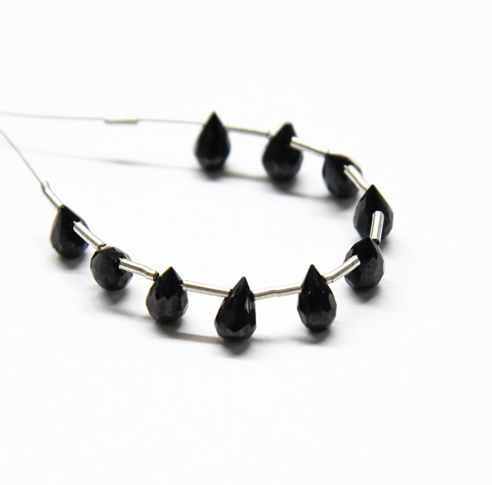 NATURAL BLACK SPINEL BEADS FACETED BRIOLETTE 4X5 - 4X6.5 MM 10 PCS (3 TASSELS): These are natural, earth mined and hand crafted with precision. Stone: Black Spinel, Shape: Faceted Briolette, Size: 4x5 - 4x6.5 mm, Weight: approx. 8 carats. The photographs are enlarged to show the