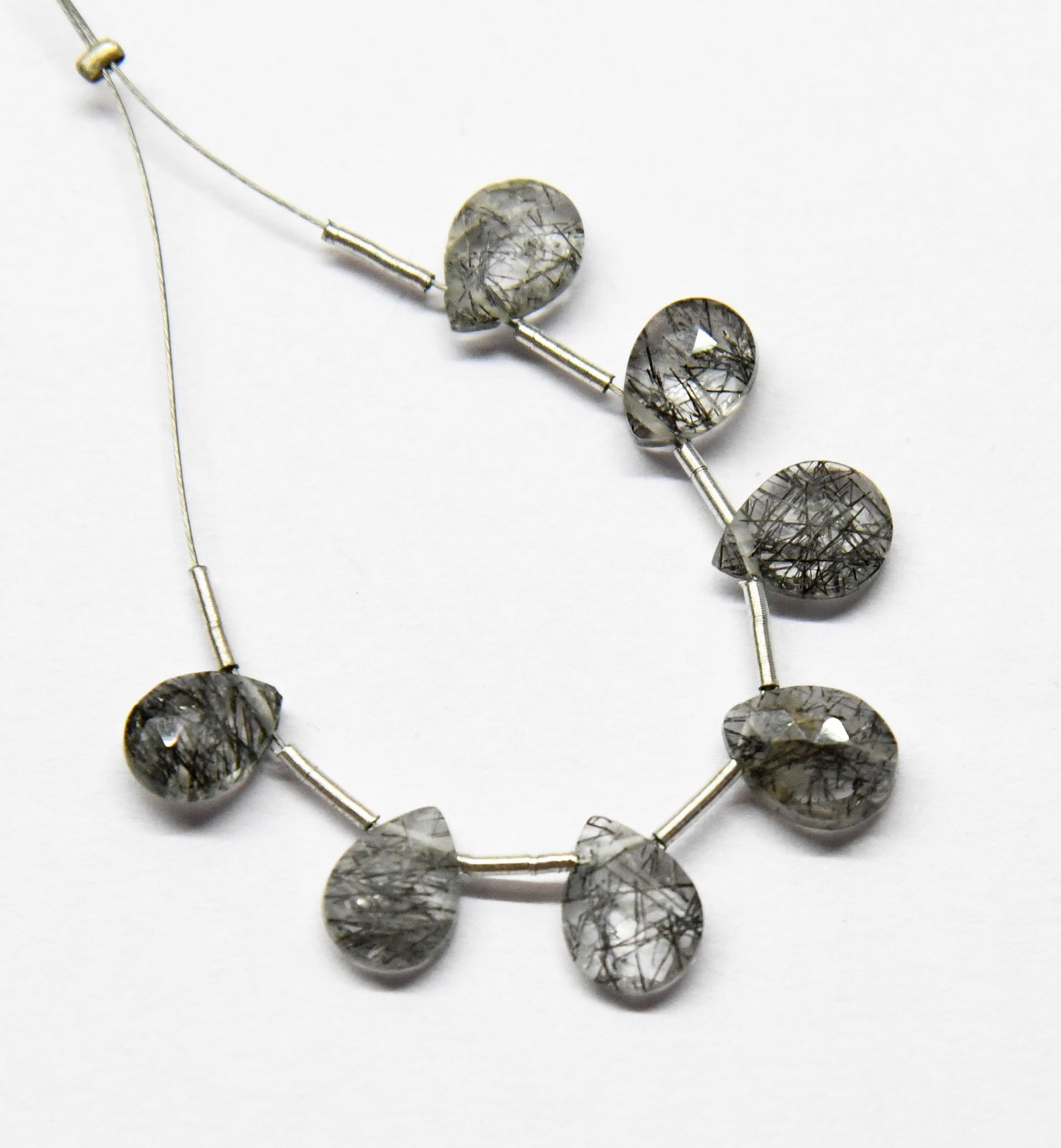 NATURAL BLACK RUTILE BEADS FACETED PEAR 6X8 - 6.5X8.5 MM 7 PCS (3 TASSELS): These are natural, earth mined and hand crafted with precision. Stone: Black Rutile, Shape: Faceted Pear, Size: 6x8 - 6.5x8.5 mm, Width: 3 - 4 mm, Weight: approx. 9 carats. The photographs are enlarge