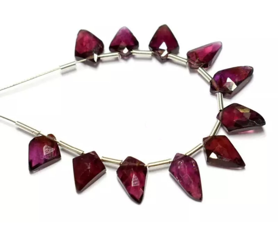NATURAL RHODOLITE GARNET BEADS FACETED FANCY 11 PCS: These are natural, earth mined and hand crafted with precision. Stone: Rhodolite Garnet, Shape: Faceted Fancy, Size: 5x8 - 5.5x9.5 mm, Width - 2.5 - 3 mm, Weight: approx. 14 carats. The photographs ar