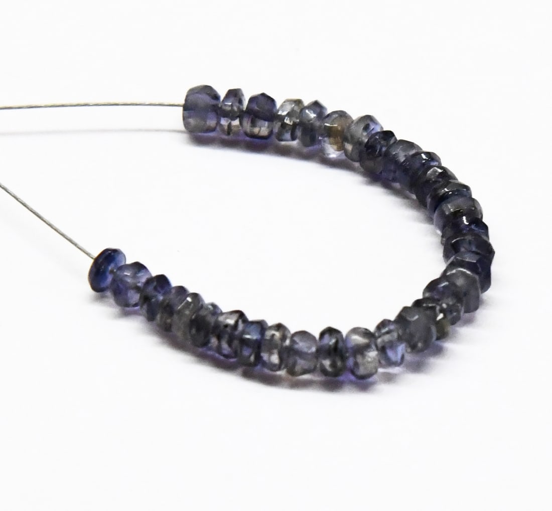 NATURAL IOLITE BEADS FACETED RONDELLE 3.5 MM 33 PCS (2 TASSELS): These are natural, earth mined and hand crafted with precision. Stone: Iolite, Shape: Faceted Rondelle, Size: 3.5 mm, Width: 1.5 - 2 mm, Weight: approx. 6 carats. The photographs are enlarged to show