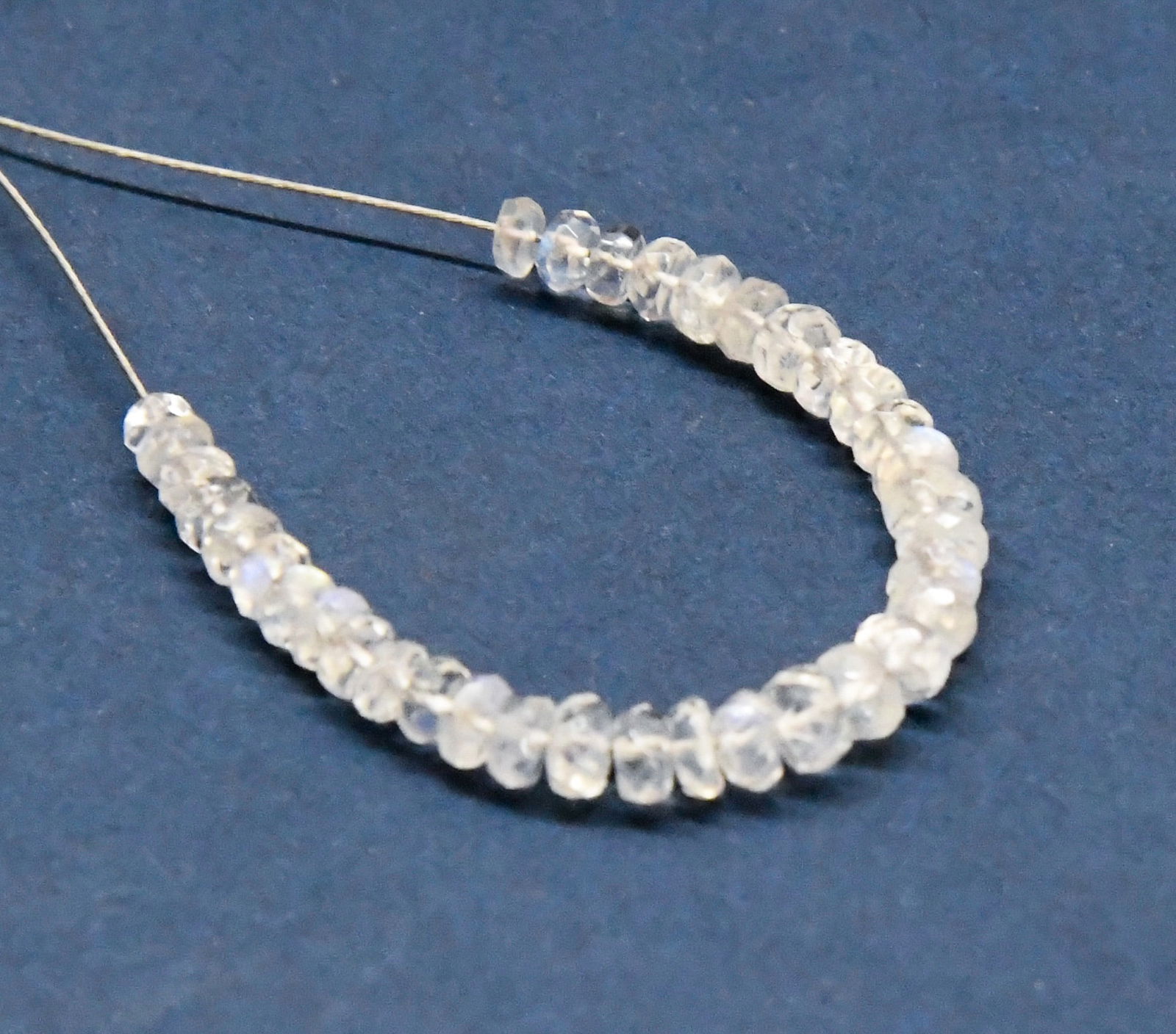 NATURAL RAINBOW MOONSTONE BEADS FACETED RONDELLE 2.5 - 3.5 MM 35 PCS (2 TASSELS): These are natural, earth mined and hand crafted with precision. Stone: Rainbow Moonstone, Shape: Faceted Rondelle, Size: 2.5 - 3.5 mm, Width: 1.5 - 2 mm, Weight: approx. 5.50 carats. The photographs a