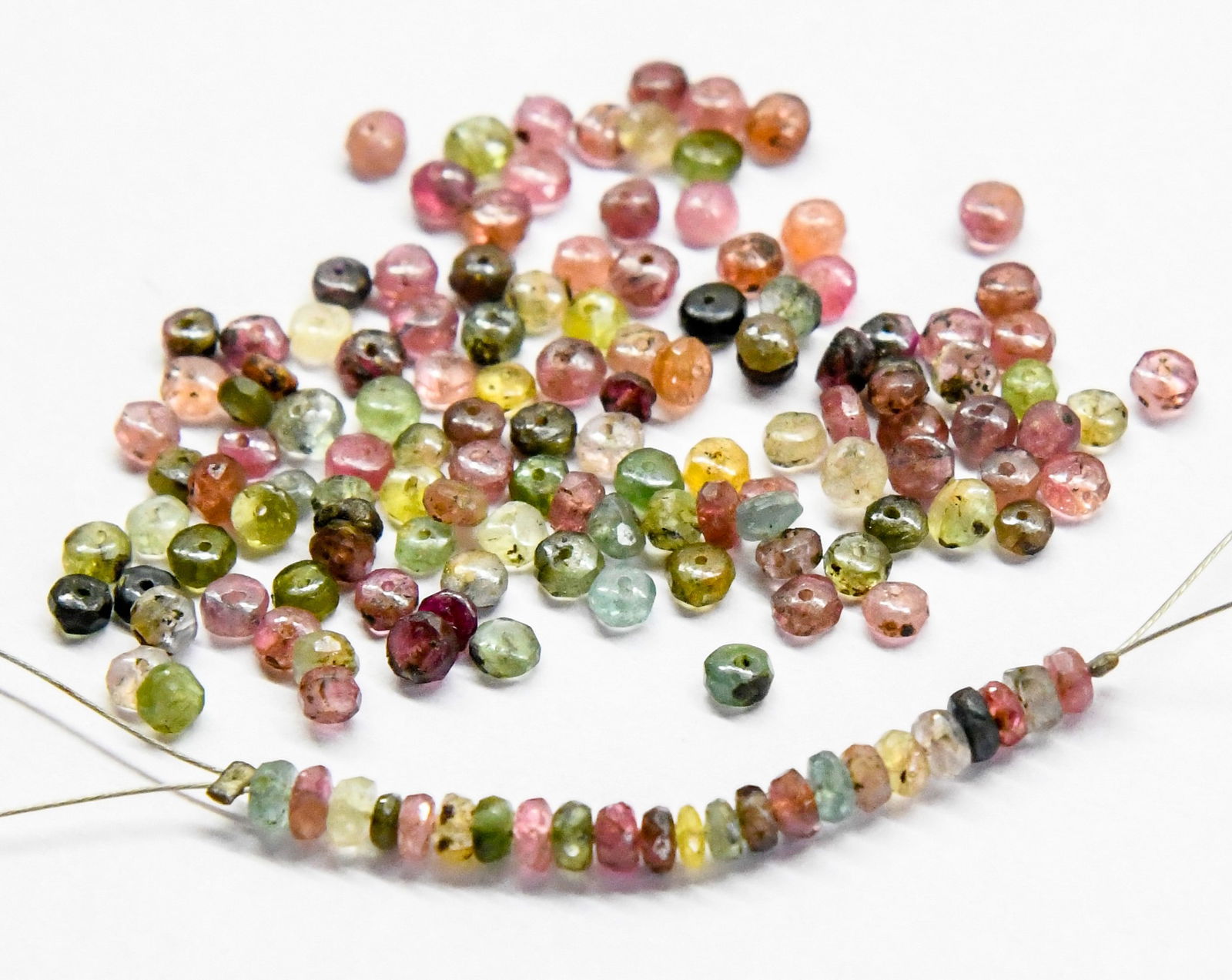 (400 PIECES) NATURAL MULTI TOURMALINE BEADS FACETED RONDELLE 2.5 - 3 MM: These are natural, earth mined and hand crafted with precision. Stone: Multi Tourmaline, Shape: Faceted Rondelle, Size: 2.5 - 3 mm, Width: 1 - 2 mm, Weight: approx. 55 carats. The photographs are enla