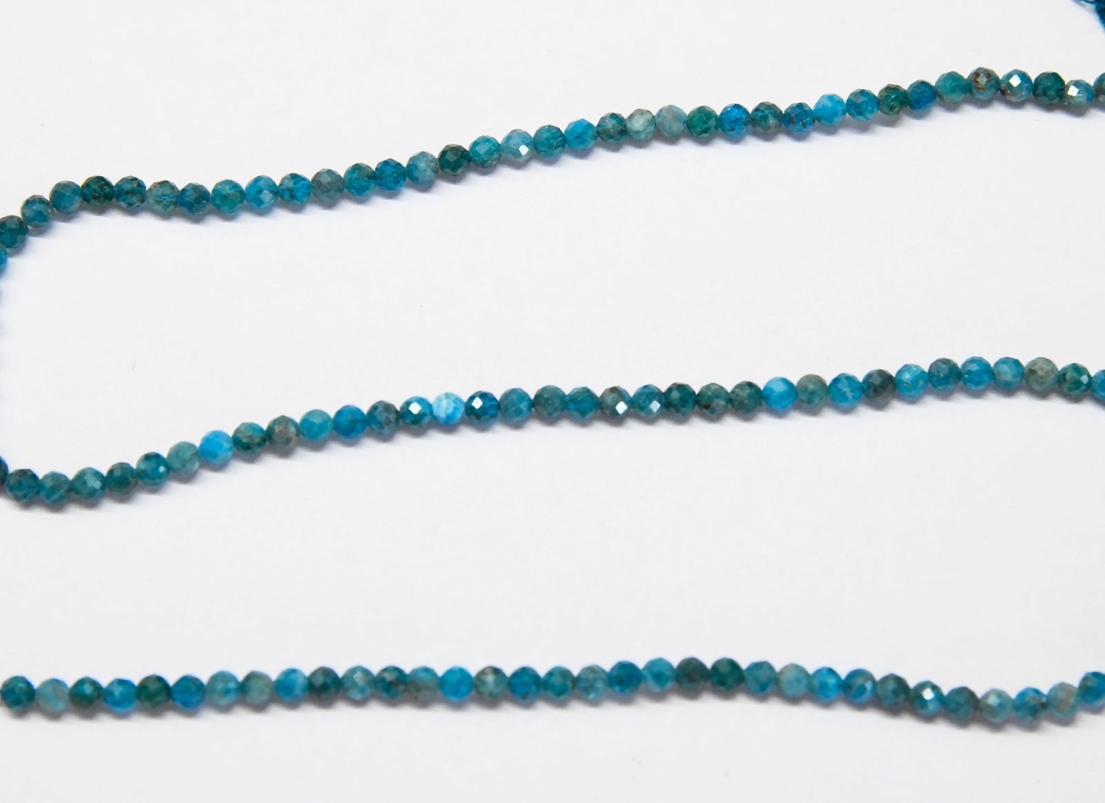 16" STRAND NATURAL NEON APATITE BEADS FACETED ROUND 3.5 MM: These are natural, earth mined and hand crafted with precision. Stone: Apatite, Shape: Faceted Round, Size: 3.5 mm, Weight: approx. 37 carats. The photographs are enlarged to show the clarity and cuts