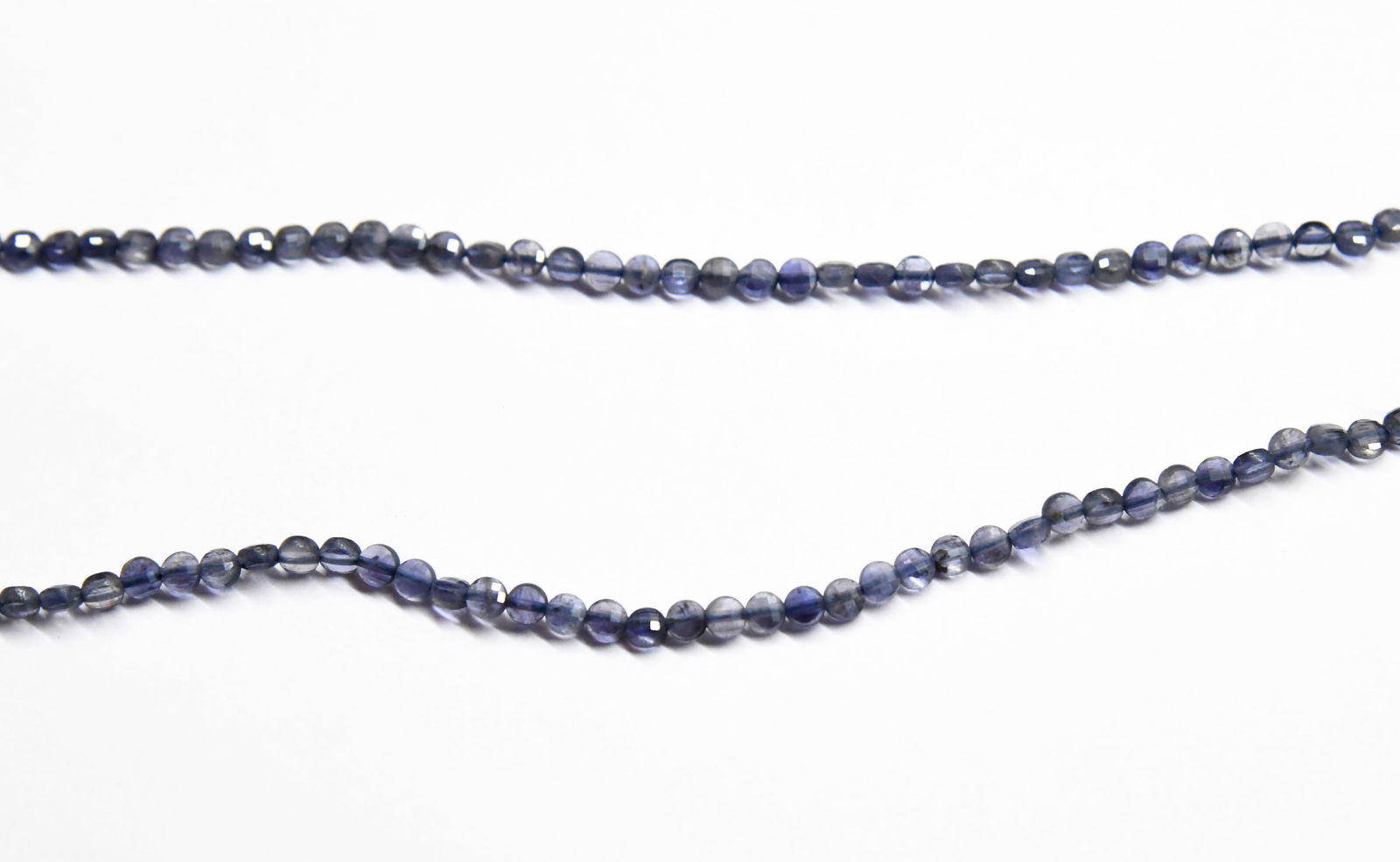 16" STRAND NATURAL IOLITE BEADS FACETED COIN 4 MM: These are natural, earth mined and hand crafted with precision. Stone: Iolite, Stone Shape: Faceted Coin, Stone Size: 4 mm, Width: 2.5 mm, Weight: approx. 33 carats. The photographs are enlarged to sh