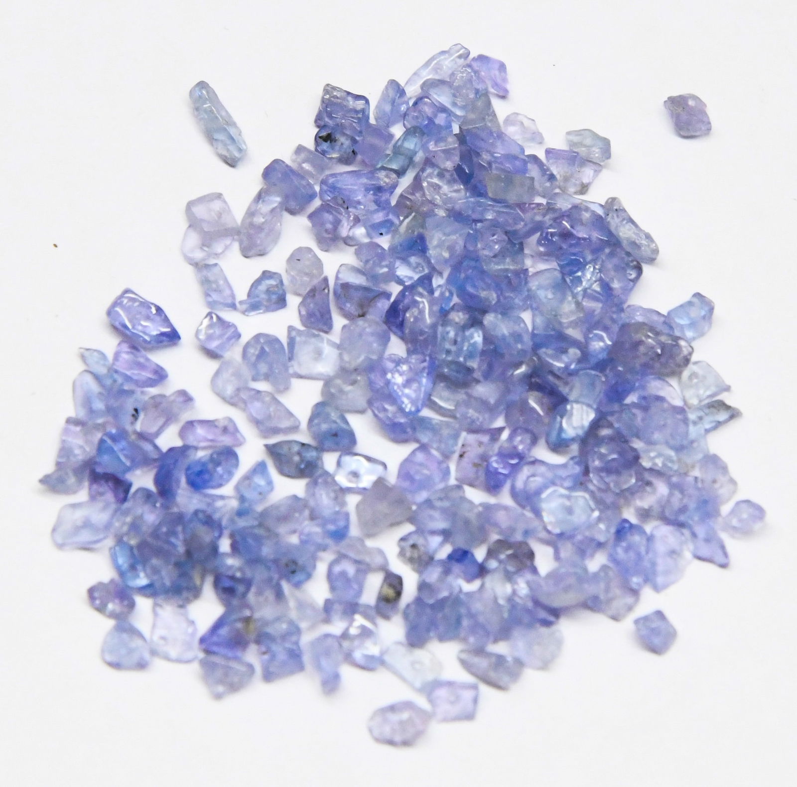 (500 PIECES) NATURAL TANZANITE BEADS CHIPS 2X3 - 3X5 MM: These are natural, earth mined and hand crafted with precision. Stone: Tanzanite, Stone Shape: Chips, Stone Size: 2x3 - 3x5 mm, Width: 1 - 2 mm, Weight: approx. 80 carats. The photographs are enlarged