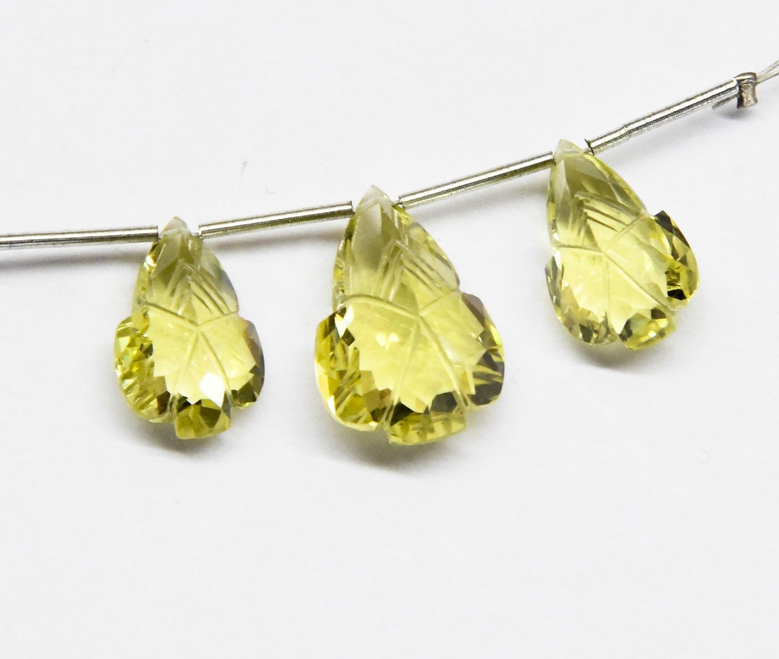 NATURAL LEMON QUARTZ CARVED PEAR FANCY 9X14 - 11X16 MM 3 PC: These are natural, earth mined and hand crafted with precision. Stone: Lemon Quartz, Stone Shape: Carved Pear Fancy, Stone Size: 9x14 - 11.5x16.5 mm, Width: 6.5 - 8 mm, Weight: approx. 16 carats. The