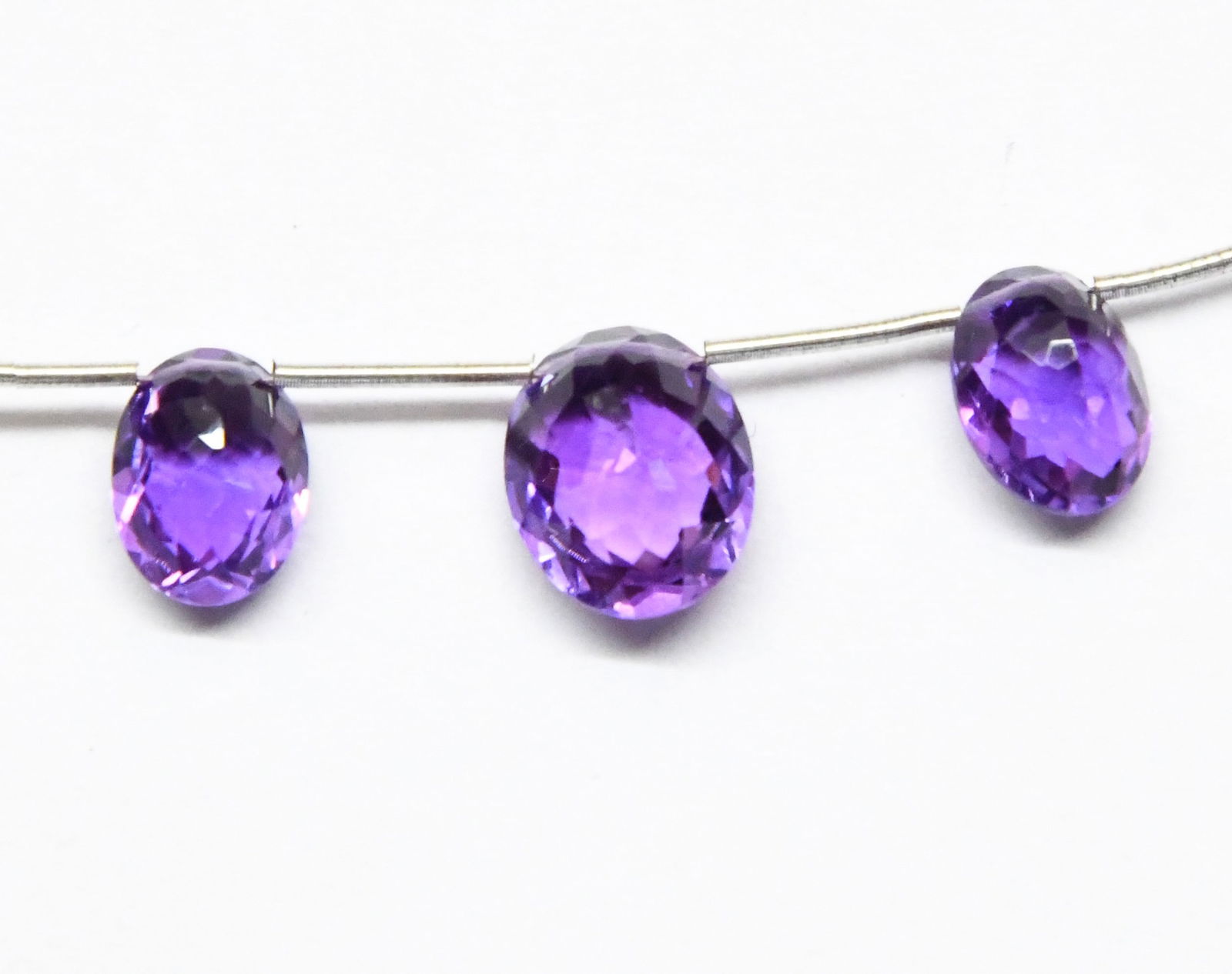 NATURAL AMETHYST BEADS FACETED OVAL 8X10 - 10X12 MM 3 PC: These are natural, earth mined and hand crafted with precision. Stone: Amethyst, Stone Shape: Faceted Oval, Stone Size: 8x10.5 - 10x12 mm, Width: 6 - 7 mm, Weight: approx. 10.50 carats. The photograph