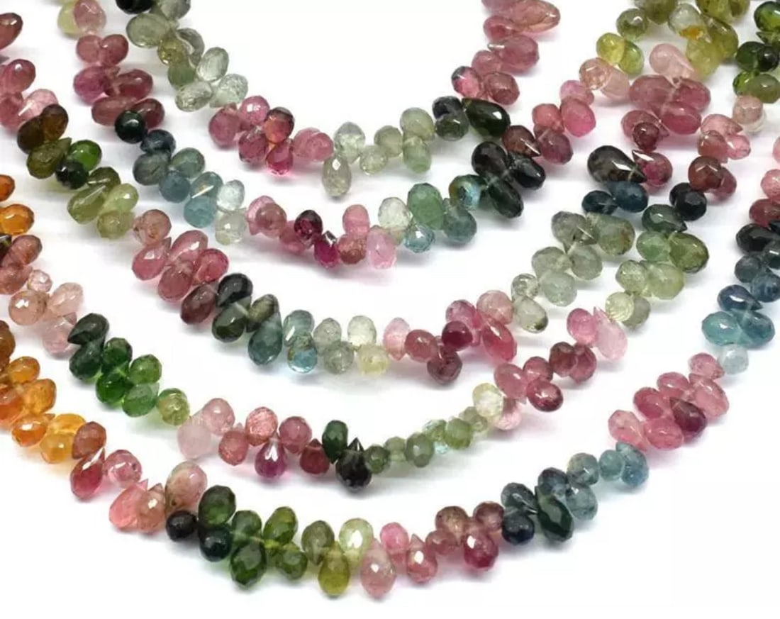 9" NATURAL MULTI TOURMALINE BEADS FACETED BRIOLETTE: These are natural, earth mined and hand crafted with precision. Stone: Multi Tourmaline, Shape: Faceted Briolette, Size: 3x5 - 3.5x6 mm, Length: 9", Weight: approx. 47 carats. The photographs are enla