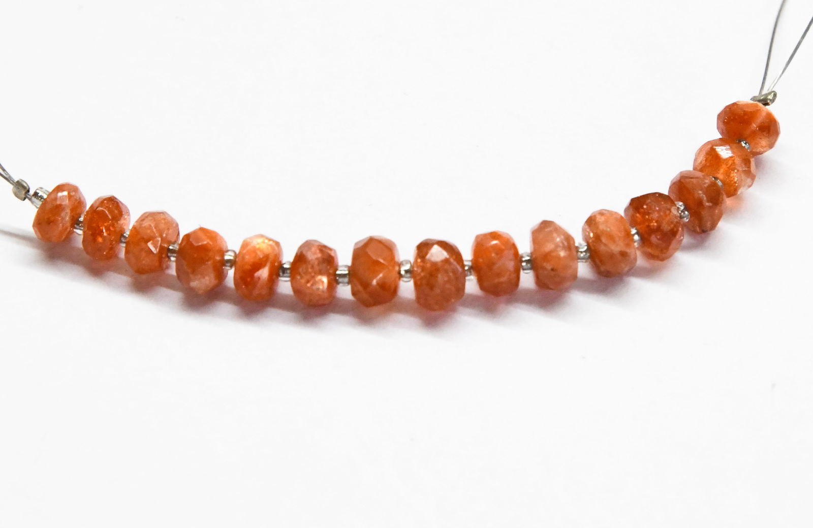 NATURAL SUNSTONE BEADS FACETED RONDELLE 5 - 5.5 MM 15 PCS: These are natural, earth mined and hand crafted with precision. Stone: Sunstone, Stone Shape: Faceted Rondelle, Stone Size: 5 - 5.5 mm, Width: 3 - 4 mm, Weight: approx. 12 carats. The photographs are