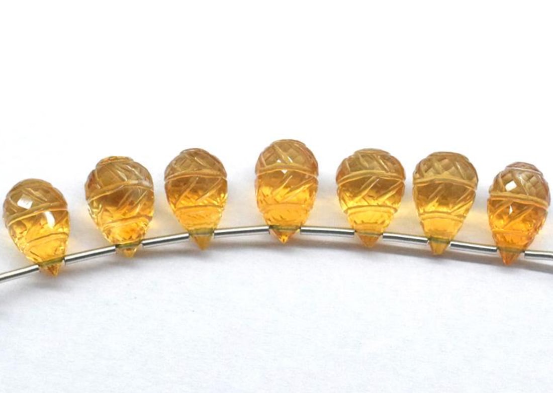 NATURAL CITRINE BEADS FACETED CARVED BRIOLETTE 6.5X11 - 7X11.5 MM 7 PCS: These are natural, earth mined and hand crafted with precision. Stone: Citrine, Stone Shape: Carved Briolette, Stone Size: 6x11 - 7x11.5 mm, Weight: approx. 24 carats. The photographs are enlarged to