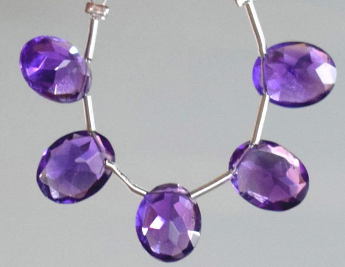 NATURAL AMETHYST BEADS FACETED OVAL 8X10 MM 5 PCS: These are natural, earth mined and hand crafted with precision. Stone: Amethyst, Stone Shape: Faceted Oval, Stone Size: 8x10 mm, Width: 4 - 5 mm, Weight: approx. 10.25 carats. The photographs are enla