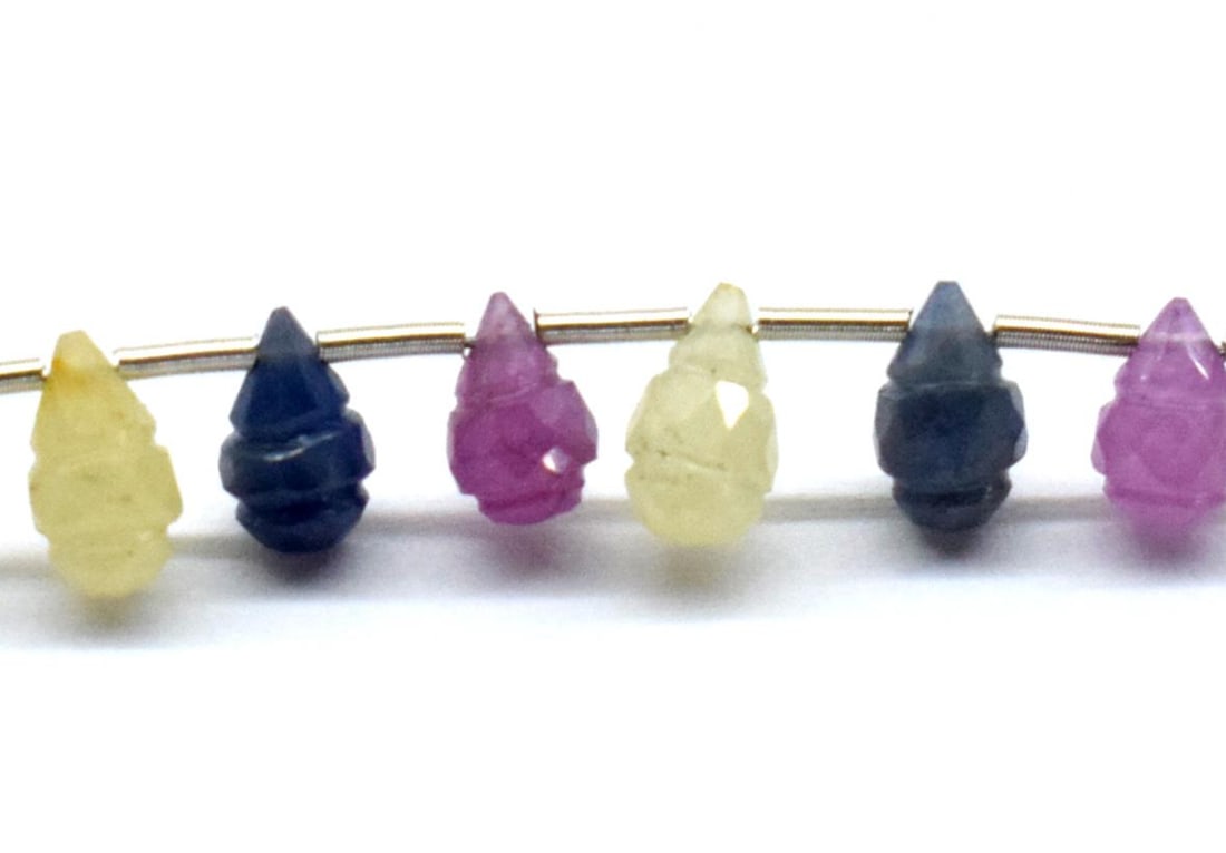 NATURAL SAPPHIRE BEADS FACETED CARVED BRIOLETTE 4X6.5 - 4.5X7.5 MM 8 PCS: These are natural, earth mined and hand crafted with precision. Stone: Multi Sapphire, Stone Shape: Carved Briolette, Stone Size: 4x6.5 - 4.5x7.5 mm, Weight: approx. 10 carats. The photographs are enl