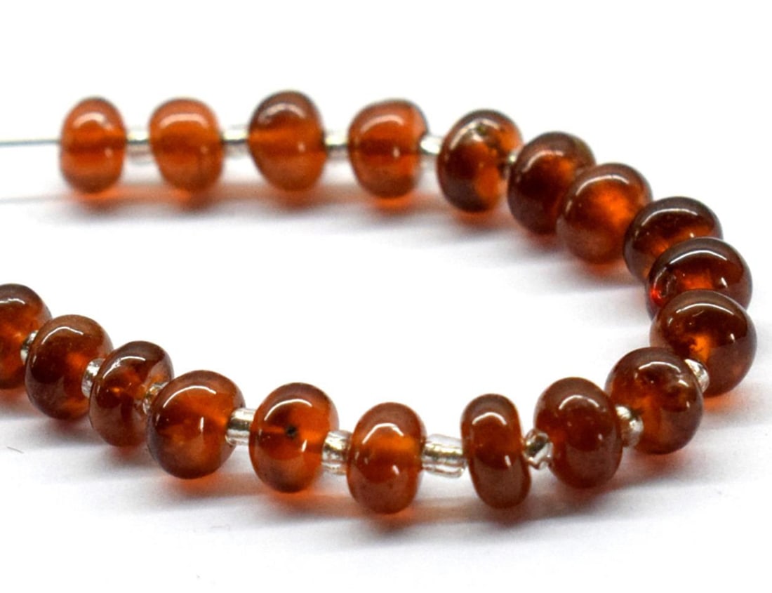 NATURAL HESSONITE GARNET BEADS RONDELLE 4 - 4.5 MM 21 PCS (4 TASSELS): These are natural, earth mined and hand crafted with precision. Stone: Hessonite Garnet, Stone Shape: Rondelle, Stone Size: 4 - 4.5 mm, Width: 2 - 3 mm, Weight: approx. 13 carats. The photographs are