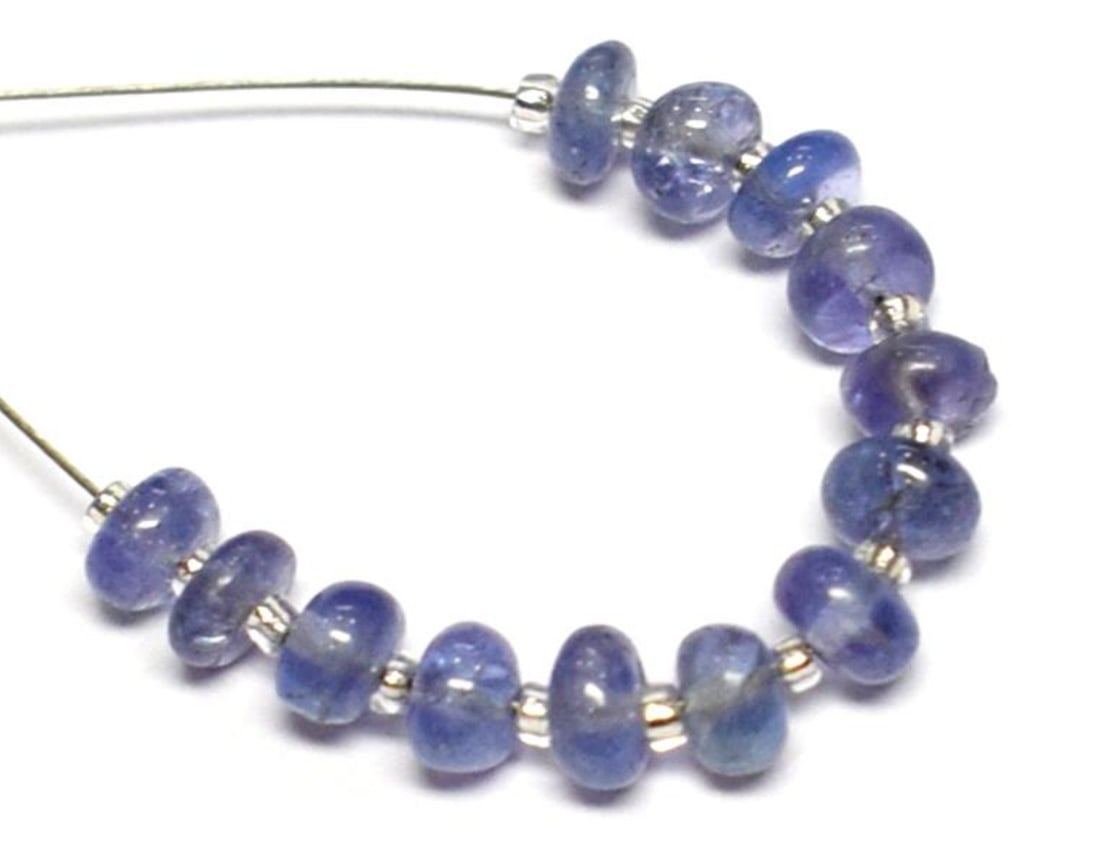 NATURAL TANZANITE BEADS RONDELLE 4 - 4.5 MM 13 PCS (2 TASSELS): These are natural, earth mined and hand crafted with precision. Stone: Tanzanite, Stone Shape: Rondelle, Stone Size: 4 - 4.5 mm, Width: 1.5 - 2.5 mm, Weight: approx. 6.70 carats. The photographs are e