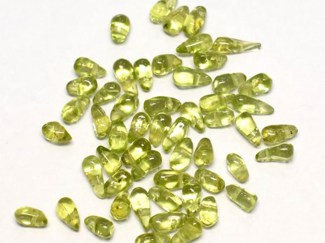 (50 PIECES) NATURAL PERIDOT BEADS BRIOLETTE 3.5X5 - 3X7.5 MM: These are natural, earth mined and hand crafted with precision. Stone: Peridot, Stone Shape: Briolette, Stone Size: 3.5x5 - 3x7.5 mm, Weight: approx. 26 carats. The photographs are enlarged to show th