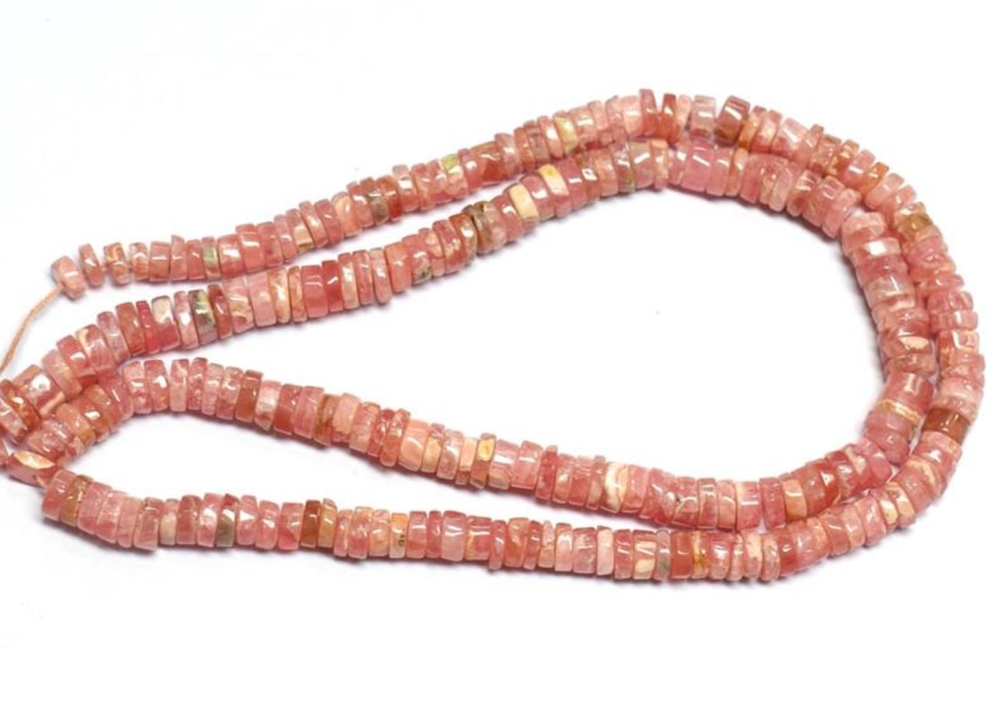 16" STRAND NATURAL RHODOCHROSITE BEADS TYRE 4 - 5.5 MM 1 LINE: These are natural, earth mined and hand crafted with precision. Stone: Rhodochrosite, Stone Shape: Tyre, Stone Size: 4 - 5.5 mm, Width: 1.5 - 2.5 mm, Weight: approx. 137 carats. The photographs are en