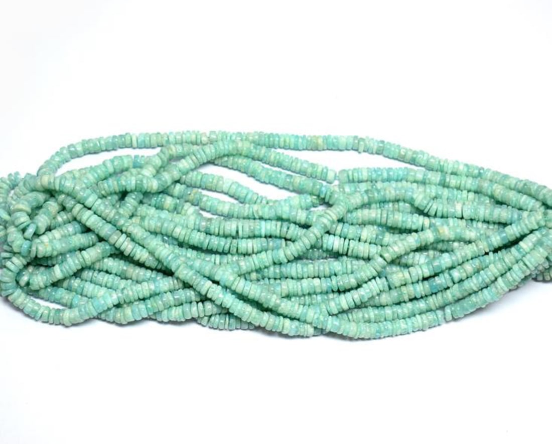 16" STRAND NATURAL AMAZONITE BEADS TYRE 5 - 5.5 MM 1 LINE: These are natural, earth mined and hand crafted with precision. Stone: Amazonite, Stone Shape: Tyre, Stone Size: 5 - 5.5 mm, Width: 1 - 2 mm, Weight: approx. 106 carats. The photographs are enlarged t