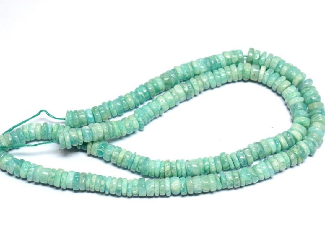 16" STRAND NATURAL AMAZONITE BEADS TYRE 6 MM 1 LINE: These are natural, earth mined and hand crafted with precision. Stone: Amazonite, Stone Shape: Tyre, Stone Size: 5.5 - 6 mm, Width: 1 - 2.5 mm, Weight: approx. 115 carats. The photographs are enlarged