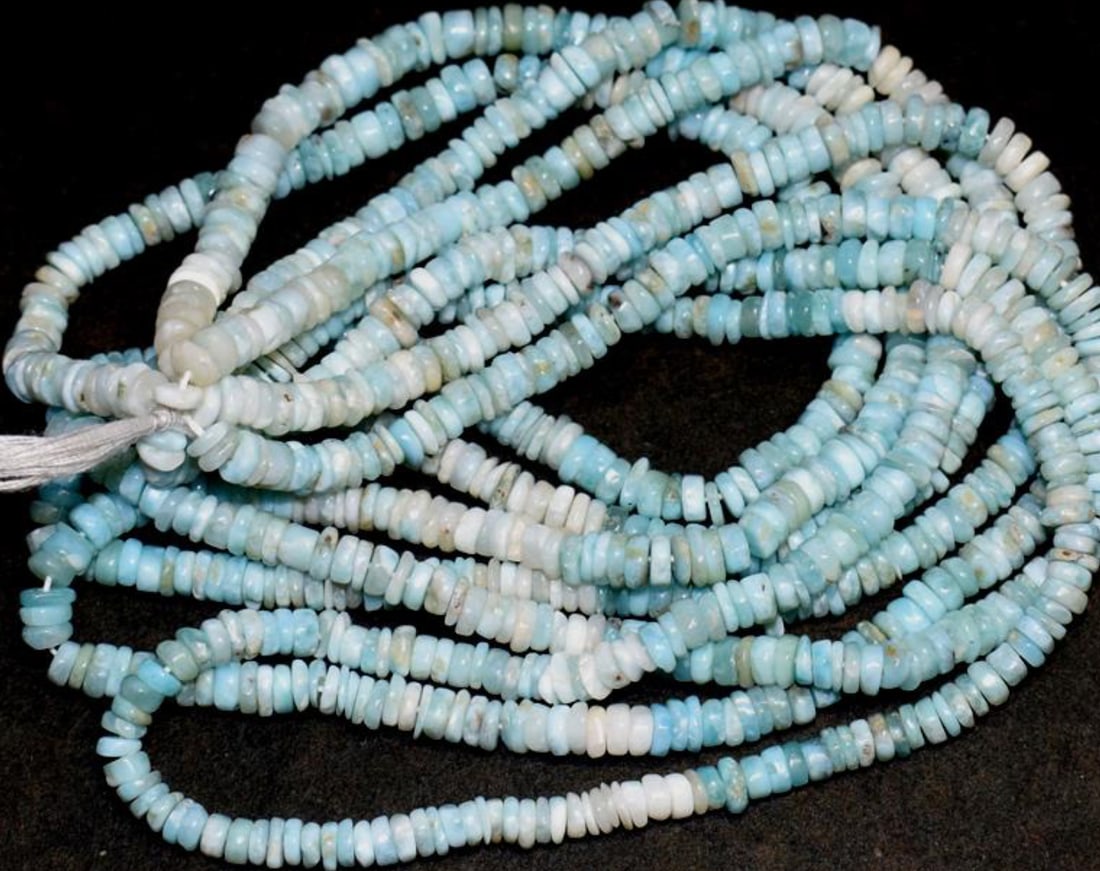 16" STRAND NATURAL LARIMAR BEADS TYRE 4 - 4.5 MM 1 LINE: These are natural, earth mined and hand crafted with precision. Stone: Larimar, Stone Shape: Tyre, Stone Size: 4 - 4.5 mm, Width: 1 - 2.5 mm, Weight: approx. 78 carats. The photographs are enlarged to