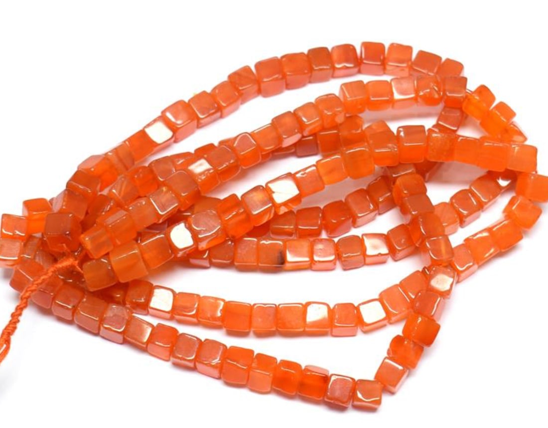 16" STRAND NATURAL CARNELIAN BEADS BOX 5 - 5.5 MM 1 LINE: These are natural, earth mined and hand crafted with precision. Stone: Carnelian, Stone Shape: Box, Stone Size: 5 - 5.5 mm, Weight: approx. 129 carats. The photographs are enlarged to show the clarity