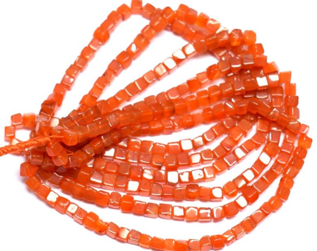 16" STRAND NATURAL CARNELIAN BEADS BOX 4 - 4.5 MM 1 LINE: These are natural, earth mined and hand crafted with precision. Stone: Carnelian, Stone Shape: Box, Stone Size: 4 - 4.5 mm, Weight: approx. 79 carats. The photographs are enlarged to show the clarity
