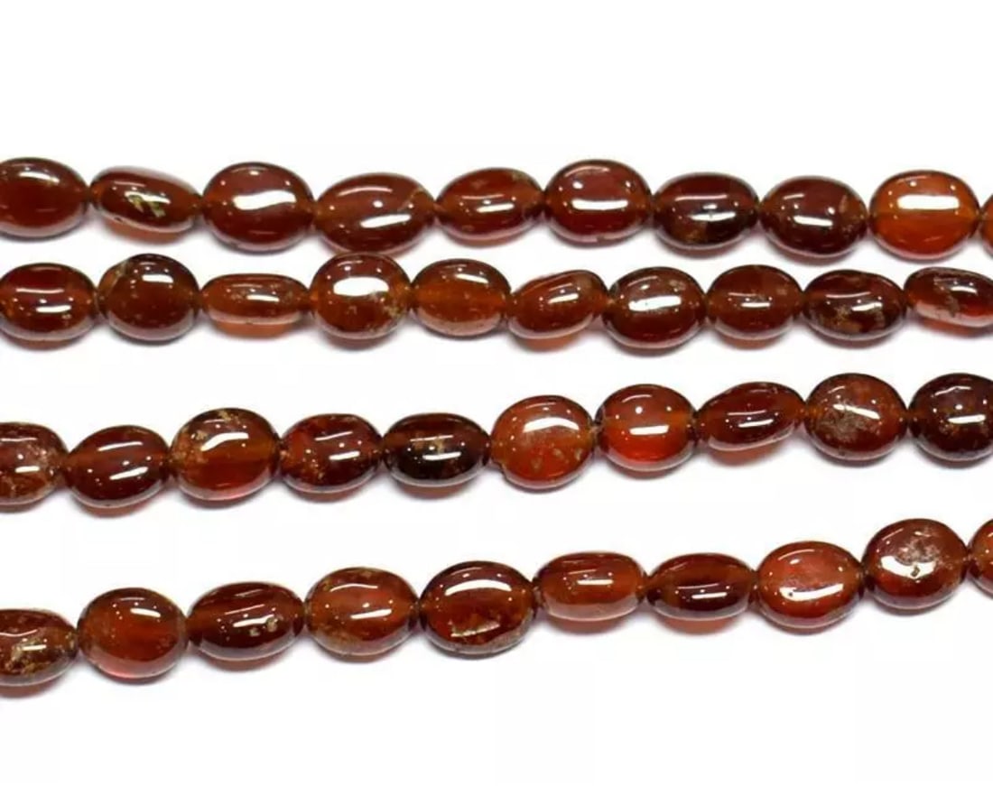 15.5" STRAND NATURAL HESSONITE GARNET BEADS OVAL 6X7 - 6.5X9 MM 1 LINE: These are natural, earth mined and hand crafted with precision. Stone: Hessonite Garnet, Stone Shape: Oval, Stone Size: 6x7 - 6.5x9mm, Width: 3.5 - 4.5mm, Weight: approx. 115 carats. The photographs a