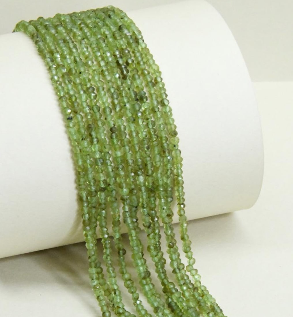 NATURAL PERIDOT FACETED BEADS RONDELLE 3 MM, 13.5" STRAND, (3 LINES): These are natural, earth mined and hand crafted with precision. Stone: Peridot, Stone Shape: Faceted Rondelle, Stone Size: 3 mm, Width: 1.5 - 2 mm, Weight: approx. 27 carats. The photographs are gener