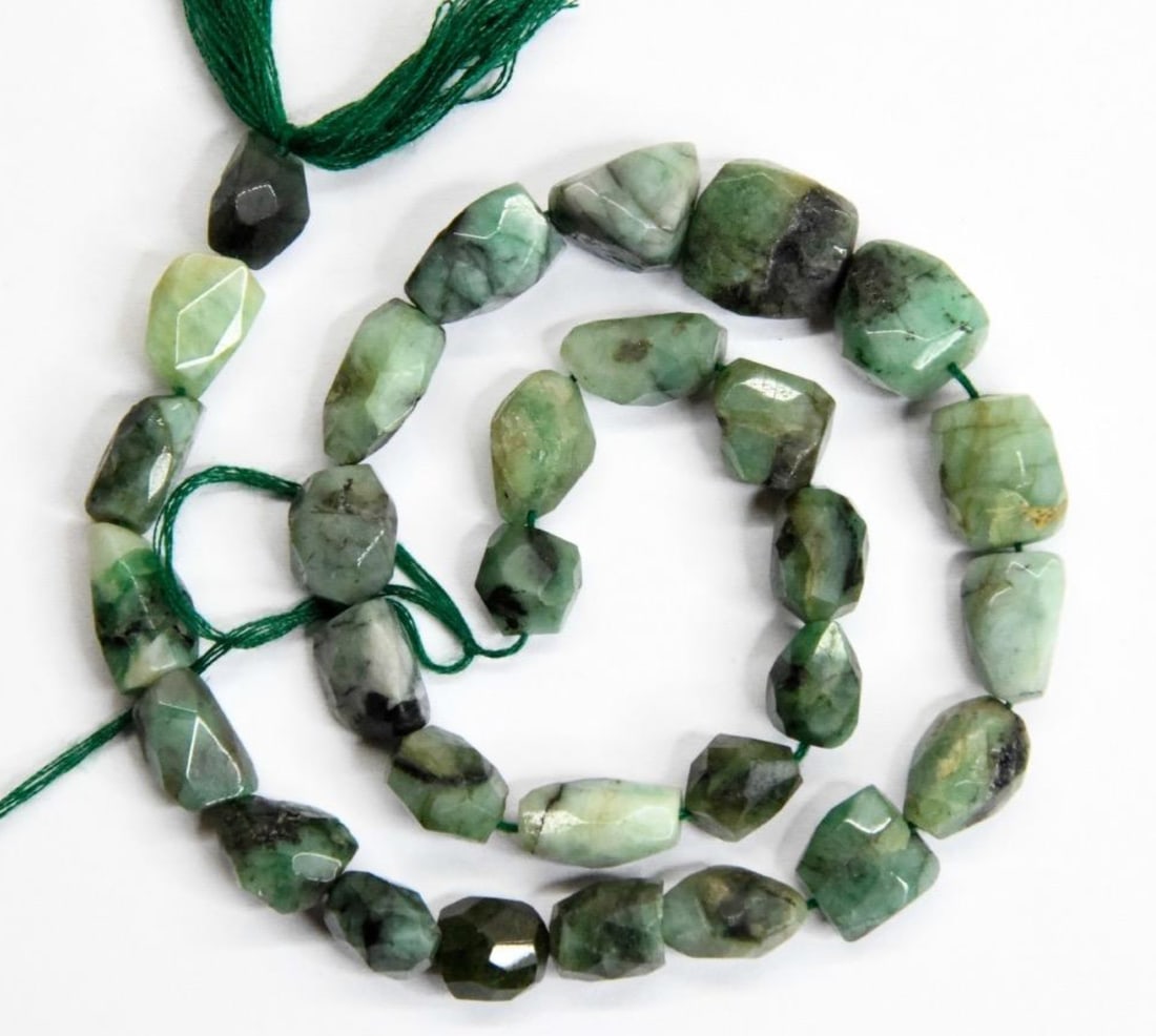 NATURAL EMERALD BEADS FACETED TUMBLE 8X9 to 12X13 MM, 12'' STRAND: These are natural, earth mined and hand crafted with precision. Stone: Emerald, Stone Shape: Faceted Tumble, Stone Size: 8x9 - 12x13 mm, Width: 4.5 - 8 mm, Weight: approx. 143 carats. The photographs