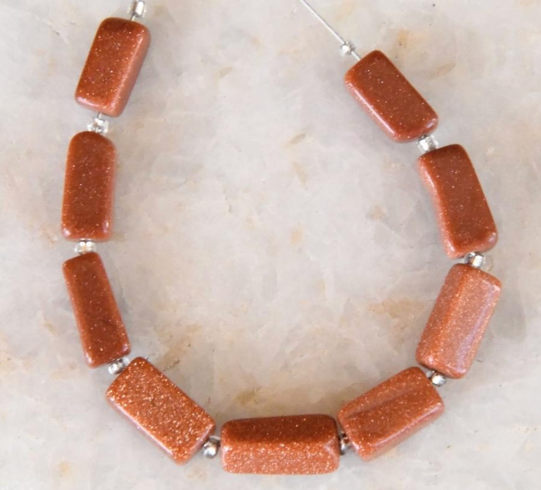 BROWN GOLDSTONE BEADS CUBE 4X7 - 4X10 MM 9 PCS, (2 TASSELS): These are natural, earth mined and hand crafted with precision. Stone: Brown Goldstone, Stone Shape: Cube, Stone Size: 4x7 - 4x10 mm, Width: 3.5 - 4 mm, Weight: approx 16 carats. The photographs are g