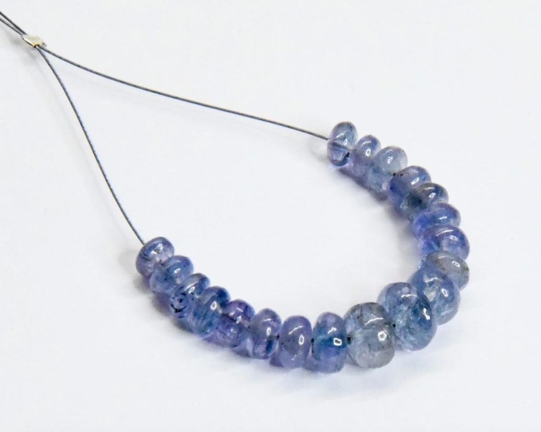 NATURAL TANZANITE BEADS RONDELLE 4 - 6.5 MM, 19 PCS: These are natural, earth mined and hand crafted with precision. Stone: Tanzanite, Stone Shape: Rondelle, Stone Size: 4 - 6.5 mm, Width: 2 - 4 mm, Weight: approx. 15 carats. The photographs are general