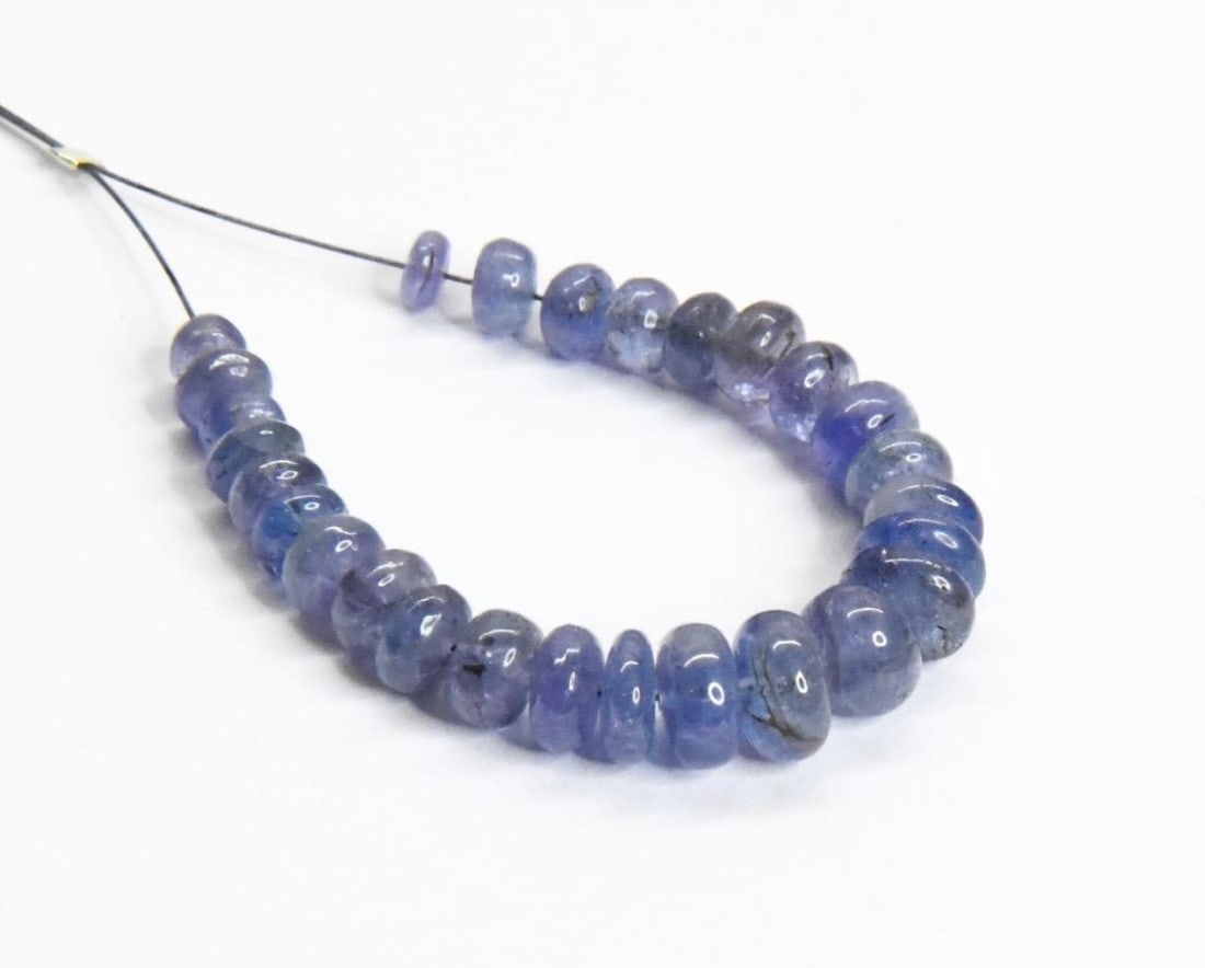NATURAL TANZANITE BEADS RONDELLE 3.5 - 6 MM, 27 PCS: These are natural, earth mined and hand crafted with precision. Stone: Tanzanite, Stone Shape: Rondelle, Stone Size: 3.5 - 6 mm, Width: 2 - 4 mm, Weight: approx. 20 carats. The photographs are general