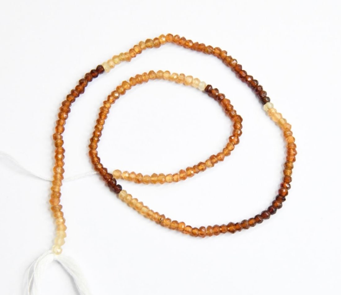 NATURAL HESSONITE GARNET BEADS FACETED RONDELLE 3 MM, 13" STRAND: These are natural, earth mined and hand crafted with precision. Stone: Hessonite Garnet, Stone Shape: Faceted Rondelle, Stone Size: 3 mm, Width: 1.5 - 2.5 mm, Weight: approx. 30 carats. The photograph