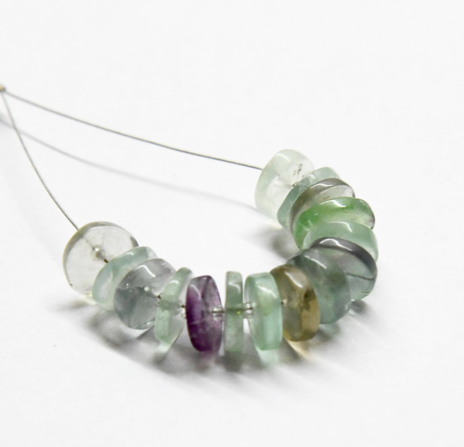 NATURAL MULTI FLUORITE BEADS TYRE 8 MM - 15 PCS (2 TASSELS): These are natural, earth mined and hand crafted with precision. Stone: Multi Fluorite, Stone Shape: Tyre, Stone Size: 8 mm, Width: 1.5 - 2.5 mm, Weight: approx. 23 carats. The photographs are generall