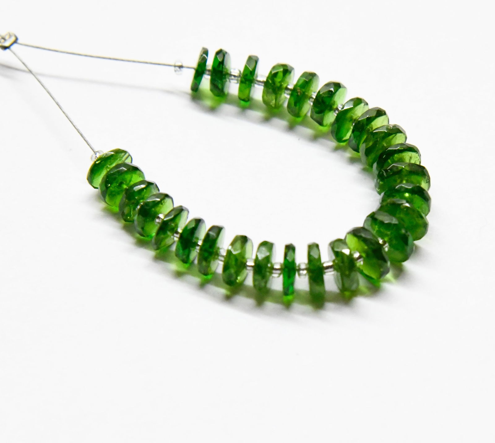 NATURAL CHROME DIOPSIDE BEADS FACETED TYRE 5 - 6.6 MM - 27 PCS (2 TASSELS): These are natural, earth mined and hand crafted with precision. Stone: Chrome Diopside, Stone Shape: Faceted Tyre, Stone Size: 5 - 6.5 mm, Width: 1 - 2 mm, Weight: approx. 16 carats. The photographs a