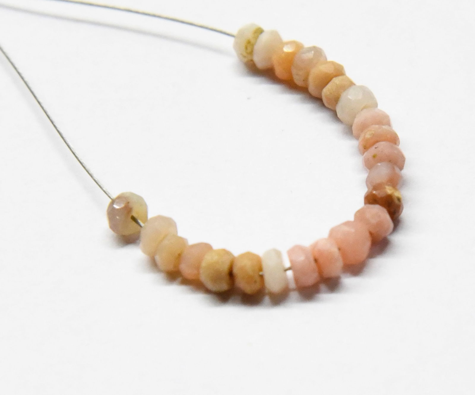 NATURAL PINK OPAL BEADS FACETED RONDELLE 3 MM 23 PCS: These are natural, earth mined and hand crafted with precision. Stone: Pink Opal, Stone Shape: Faceted Rondelle, Stone Size: 3 mm, Width: 1.5 - 2 mm, Weight: approx. 3 carats. The photographs are gene