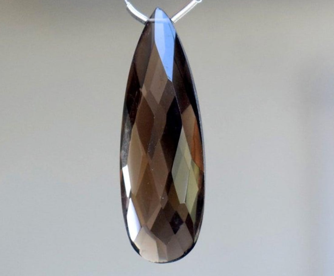 NATURAL SMOKY QUARTZ BEAD FACETED PEAR 11X33 MM 1 PC: These are natural, earth mined and hand crafted with precision. Stone: Smoky Quartz, Stone Shape: Faceted Pear, Stone Size: 11x13 mm, Width: 6.5 - 7 mm, Weight: approx. 16.2 carats. The photographs ar