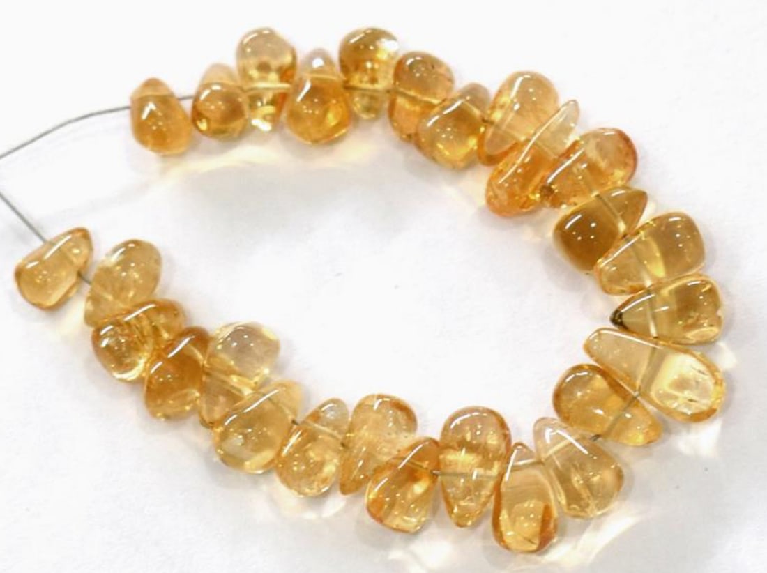 NATURAL CITRINE BEADS BRIOLETTE 3X5 - 3X8 MM 31 PCS - (4 TASSELS): These are natural, earth mined and hand crafted with precision. Stone: Citrine, Stone Shape: Briolette, Stone Size: 3x5 - 3x8 mm, Weight: approx. 13.5 carats. The photographs are generally enlarged to