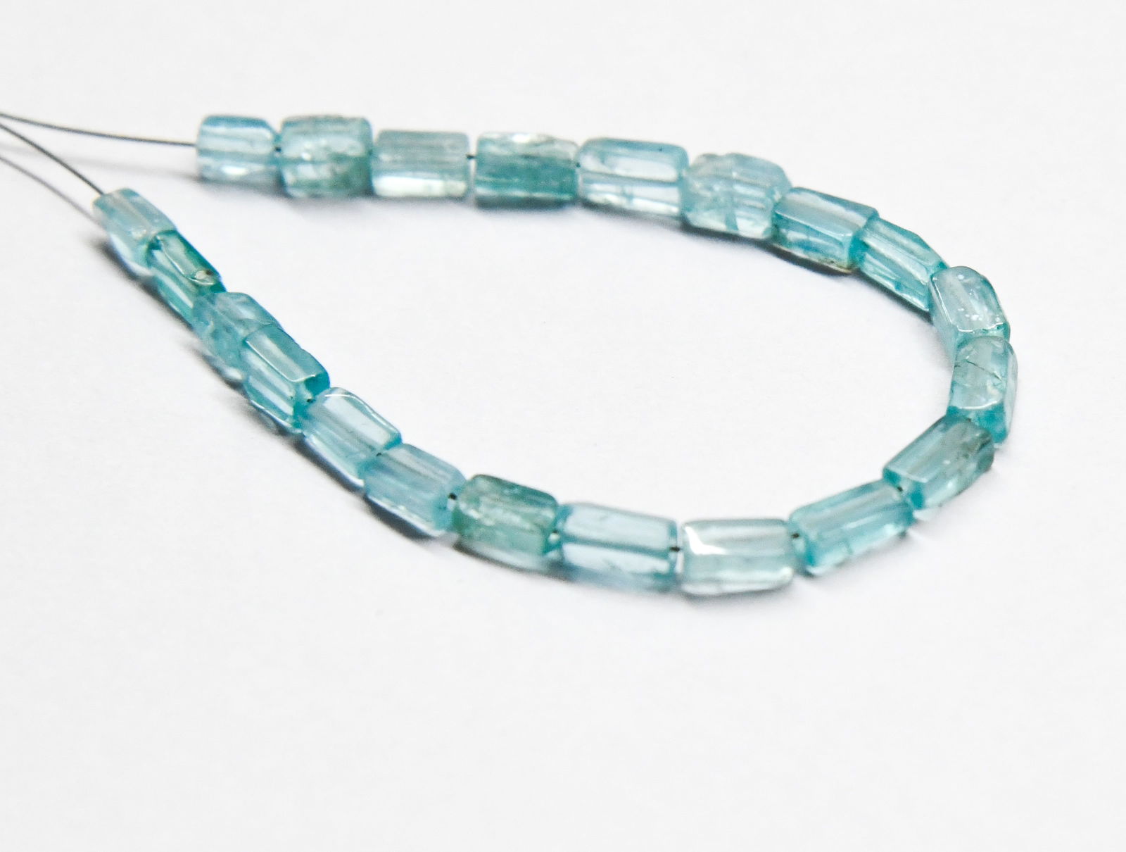 NATURAL APATITE BEADS CUBE 2X4 - 3X6 MM, 21 PCS: These are natural, earth mined and hand crafted with precision. Stone: Apatite, Stone Shape: Cube, Stone Size: 2.5x4.5 - 3x6 mm, Width: 2 - 2.5 mm, Weight: approx. 10 carats. The photographs are gener