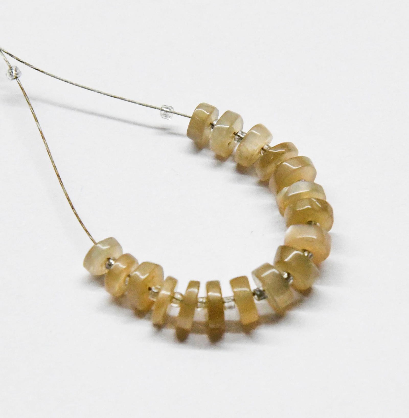 NATURAL GREY MOONSTONE BEADS TYRE 4.5 - 5.5 MM, 17 PCS: These are natural, earth mined and hand crafted with precision. Stone: Grey Moonstone, Stone Shape: Tyre, Stone Size: 4.5 - 5.5 mm, Width: 1.5 - 2.5 mm, Weight: approx. 9 carats. The photographs are g