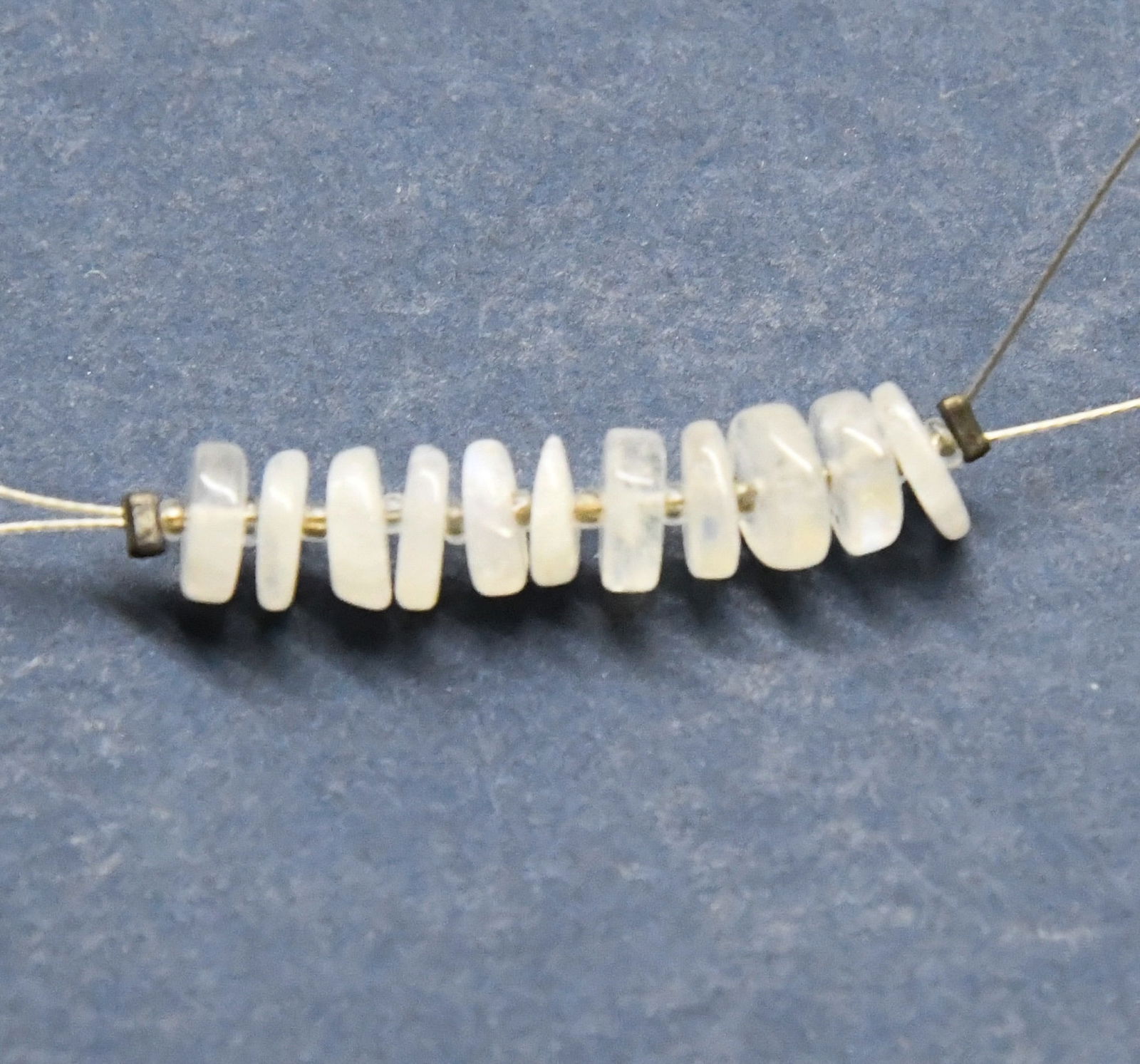 NATURAL RAINBOW MOONSTONE BEADS TYRE 6 MM, 11 PCS: These are natural, earth mined and hand crafted with precision. Stone: Rainbow Moonstone, Stone Shape: Tyre, Stone Size: 6 mm, Width: 1.5 - 2 mm, Weight: approx. 7 carats. The photographs are generall